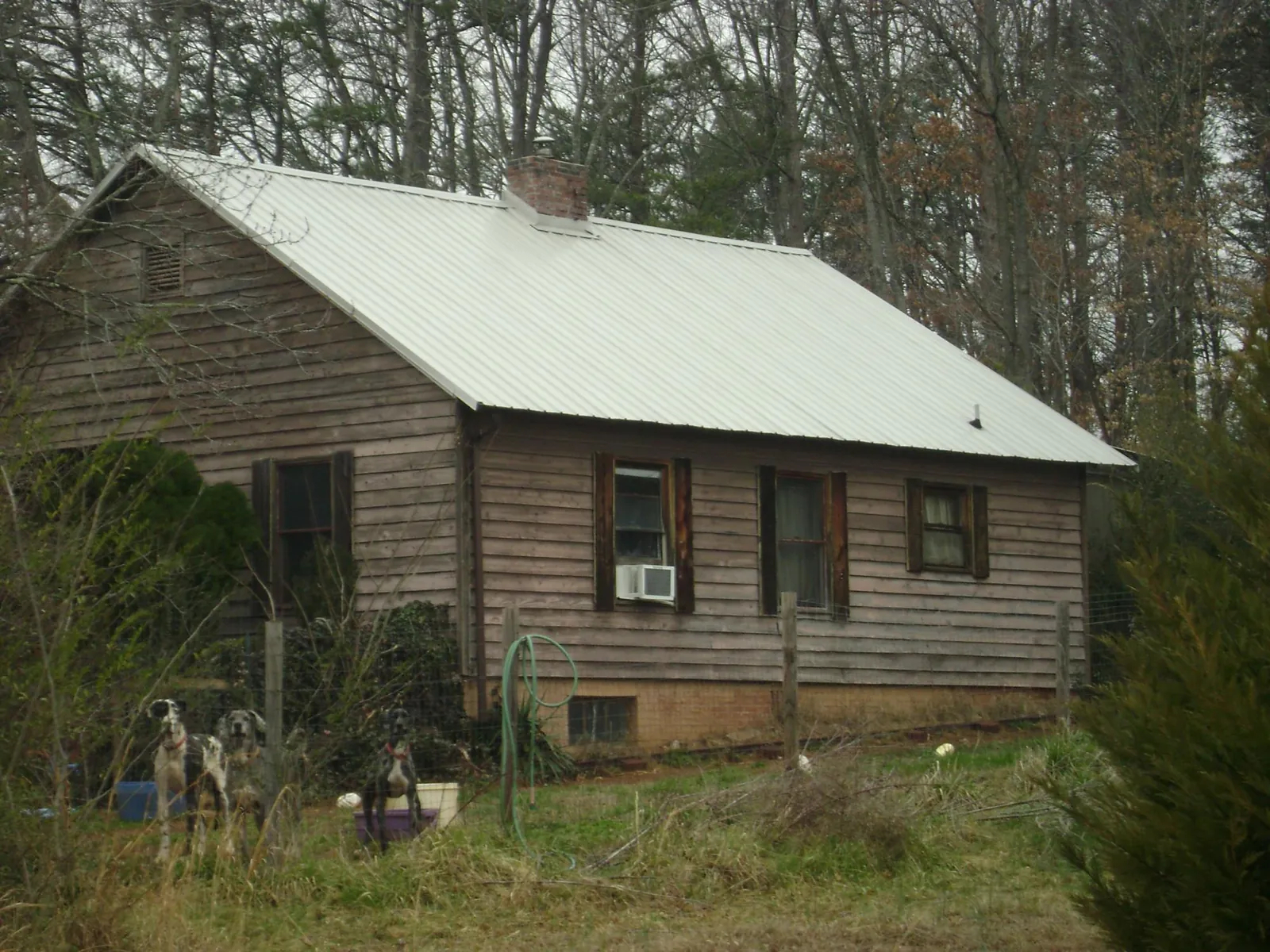 White metal roof on an old wood sided farmhouse, from a Metal Roof Installation job in Eden